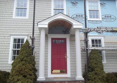 a front view of a house getting new siding