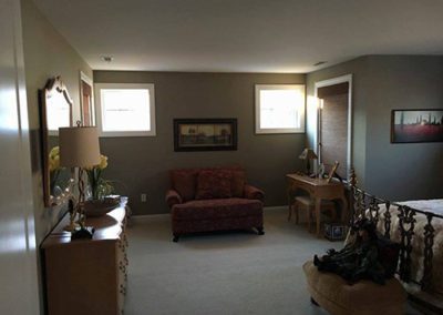 a bedroom with dark grey painted walls