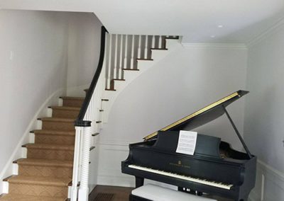 a room with a paino and white walls