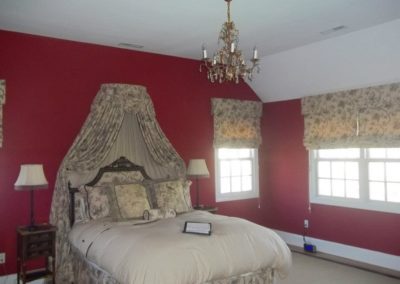 A master bedroom with red painted walls